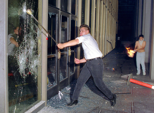 Hal Garb/AFP/Getty Images A rioter breaks a glass door of the Criminal Courts building in downtown Los Angeles on April 29, 1992.
